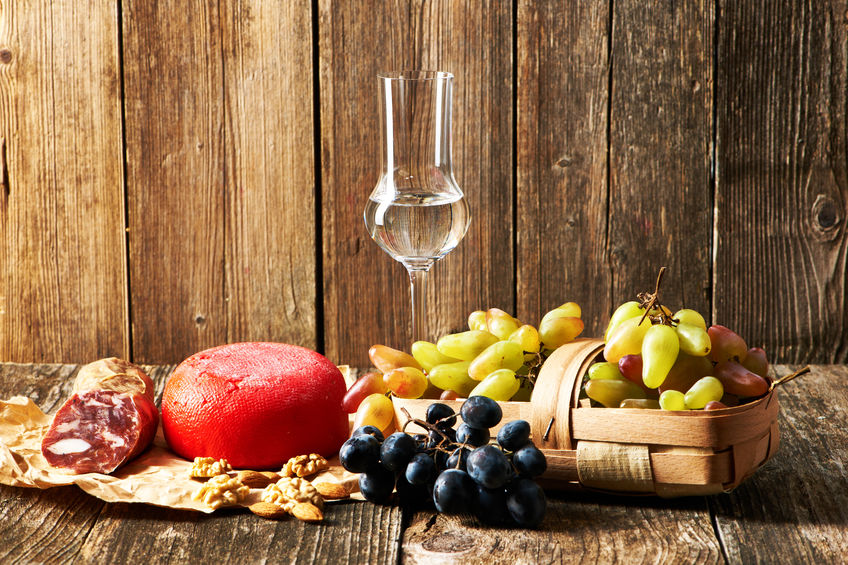Fresh grapes, grappa and cheese on old wooden table - Copyright: ClipDealer - haveseen Fresh grapes, grappa and cheese on old wooden table - Copyright: ClipDealer - haveseen